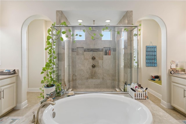 bathroom featuring a stall shower, baseboards, a garden tub, vanity, and recessed lighting