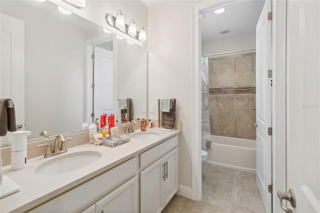 bathroom with double vanity, shower / tub combo, a sink, and toilet