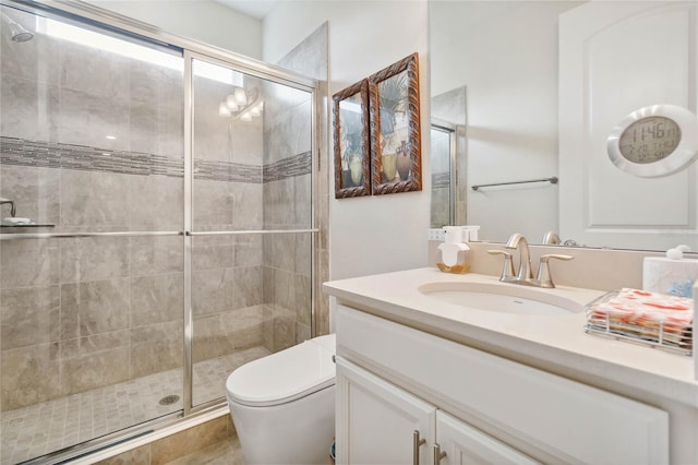 bathroom with vanity, toilet, and a shower stall