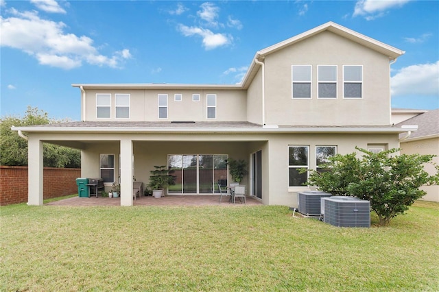 back of house featuring a patio area, a lawn, central AC, and stucco siding