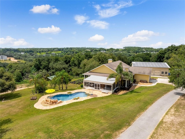 birds eye view of property with a view of trees