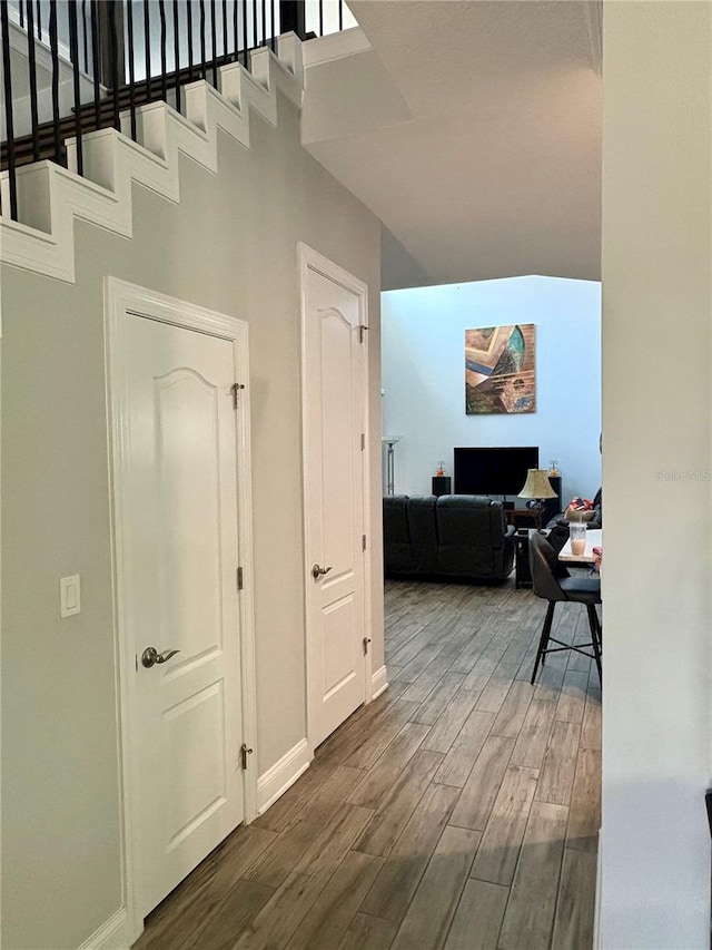 hallway with baseboards and dark wood finished floors