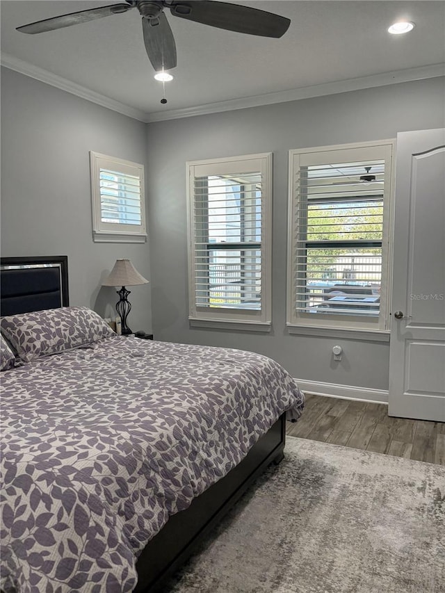 bedroom featuring baseboards, ceiling fan, ornamental molding, wood finished floors, and recessed lighting