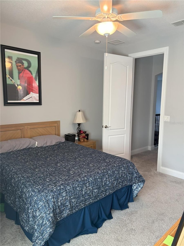 bedroom featuring carpet floors, visible vents, ceiling fan, and baseboards