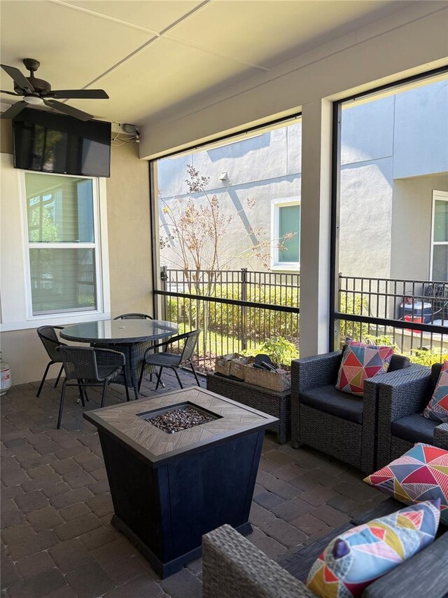 sunroom with plenty of natural light and ceiling fan