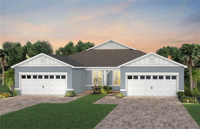 ranch-style home featuring a garage, roof with shingles, board and batten siding, and a lawn