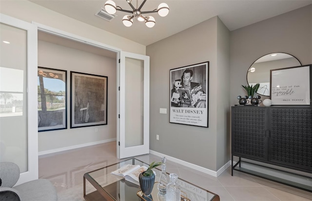 interior space featuring light tile patterned floors, baseboards, visible vents, and a notable chandelier