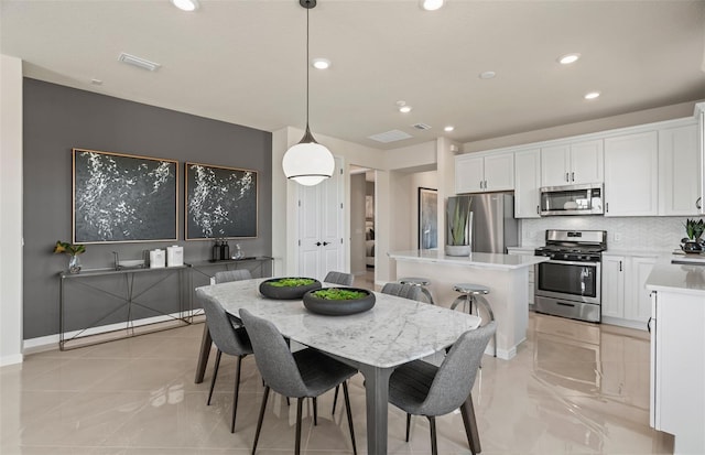 dining area with baseboards, visible vents, and recessed lighting