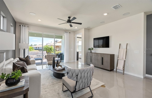 living area with recessed lighting, visible vents, ceiling fan, and baseboards