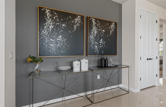 bar featuring baseboards and light tile patterned floors