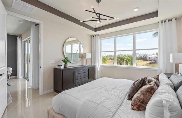 bedroom featuring a notable chandelier, a raised ceiling, visible vents, and baseboards