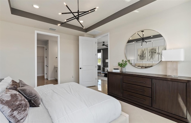 bedroom with light tile patterned flooring, recessed lighting, visible vents, a tray ceiling, and an inviting chandelier