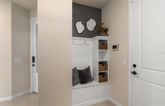 mudroom with light tile patterned floors and baseboards