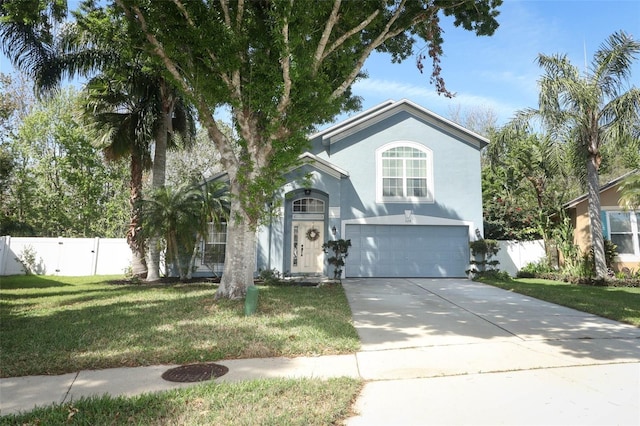 traditional-style home with an attached garage, fence, driveway, stucco siding, and a front yard