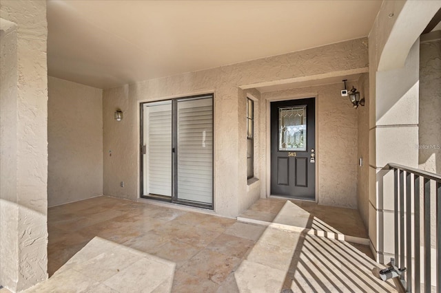 entrance to property with stucco siding