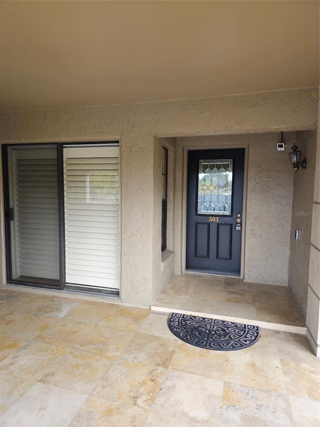 entrance to property with stucco siding