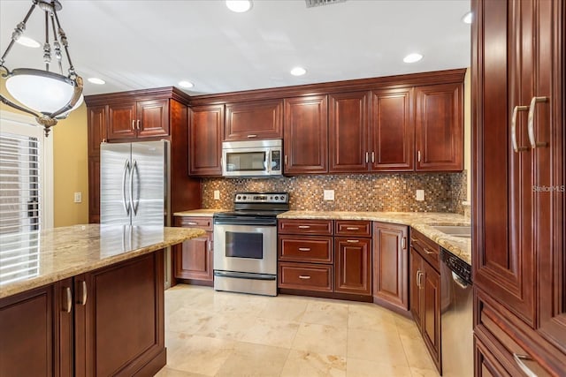 kitchen with light stone counters, stainless steel appliances, and backsplash