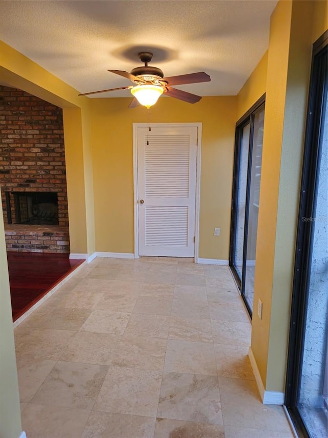 corridor featuring a textured ceiling and baseboards