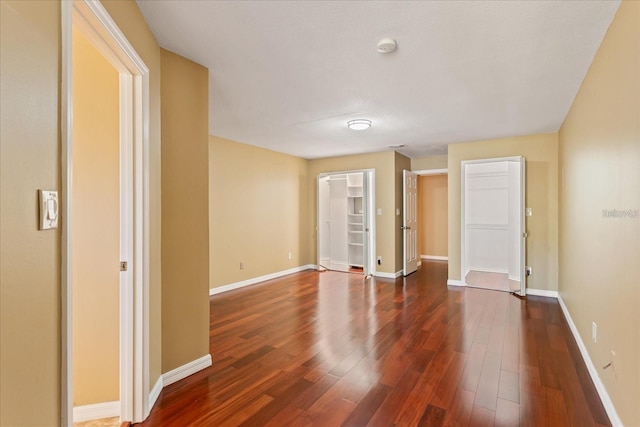 unfurnished bedroom with dark wood-style floors and baseboards