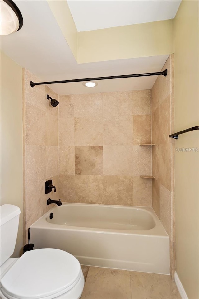 full bathroom featuring shower / bathtub combination, toilet, and tile patterned floors