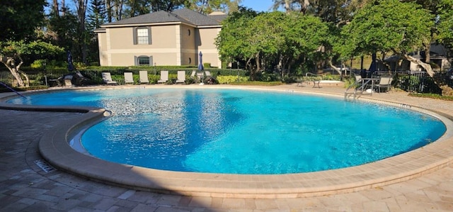 pool with fence and a patio