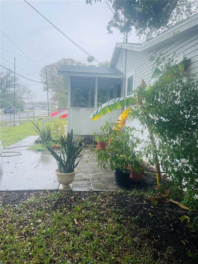 view of side of property featuring a sunroom