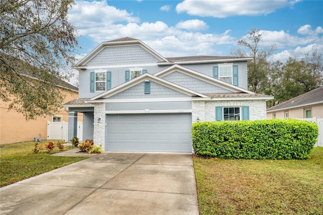 view of front of house featuring concrete driveway, an attached garage, and a front lawn