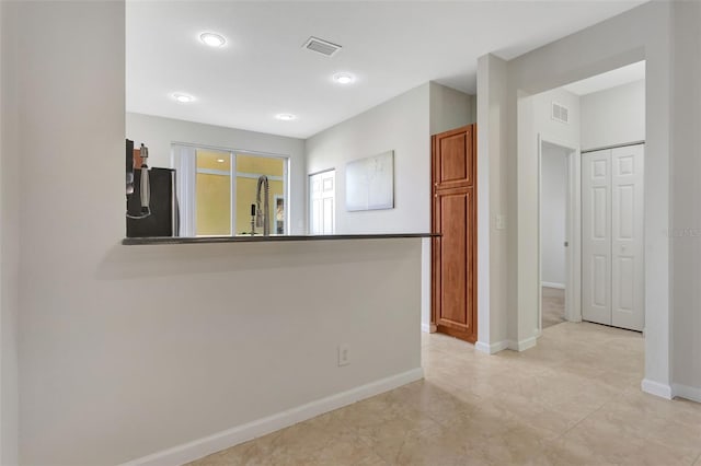 unfurnished room featuring visible vents and baseboards