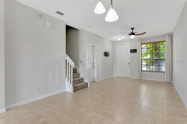 entryway featuring ceiling fan, visible vents, stairway, and baseboards