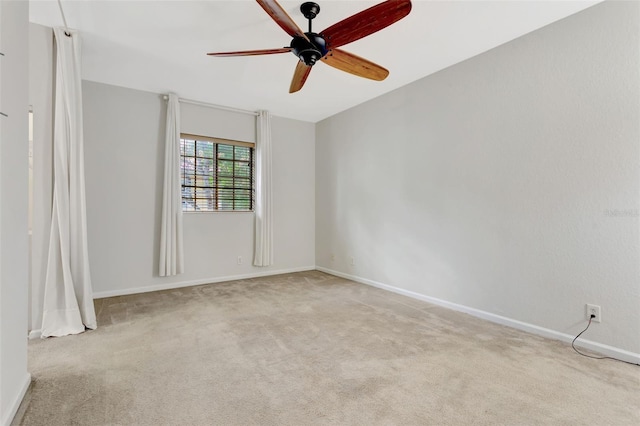 unfurnished room featuring baseboards, a ceiling fan, and light colored carpet