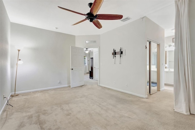 spare room featuring light carpet, baseboards, and visible vents