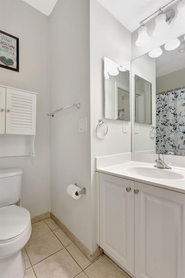 full bathroom featuring toilet, vanity, a shower with curtain, baseboards, and tile patterned floors