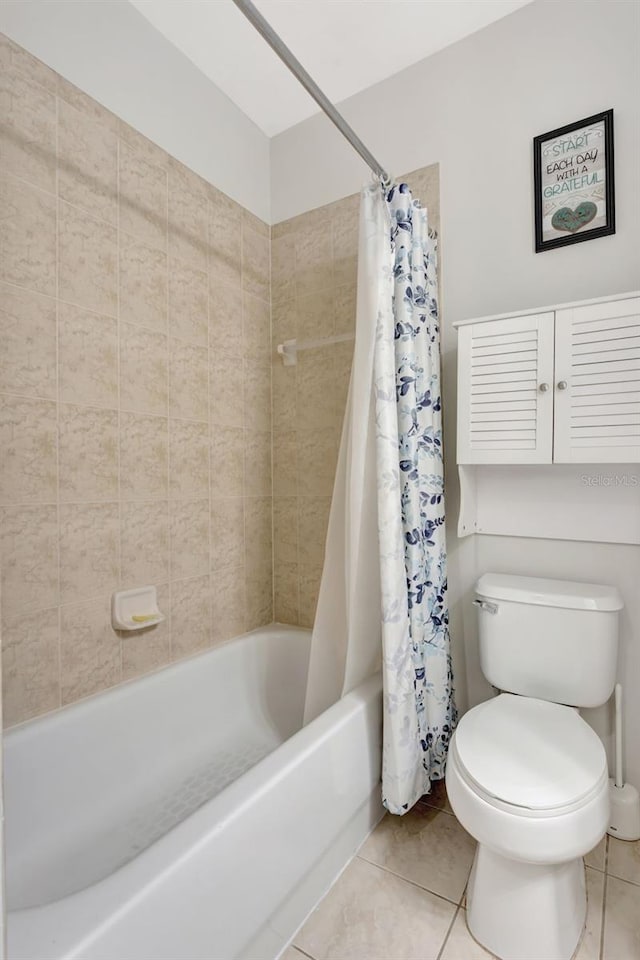 full bathroom featuring toilet, shower / tub combo, and tile patterned floors