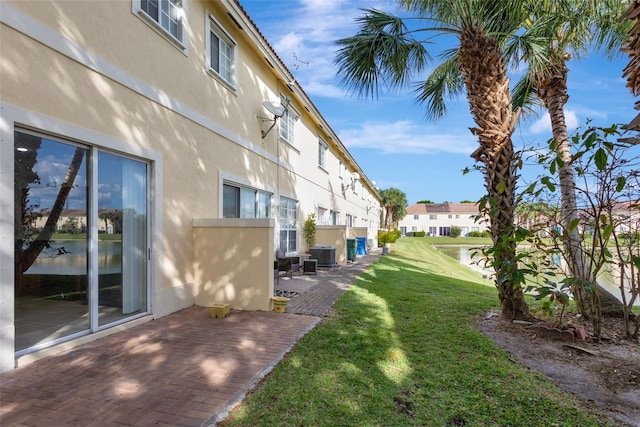 view of yard with central AC unit and a patio area