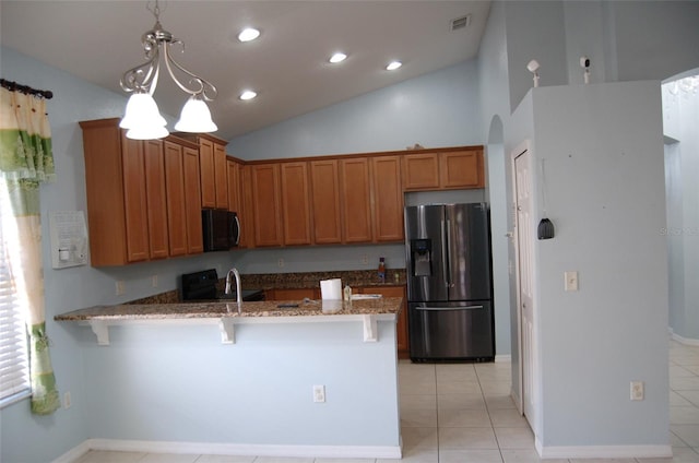 kitchen with stone countertops, a peninsula, vaulted ceiling, black appliances, and a kitchen bar