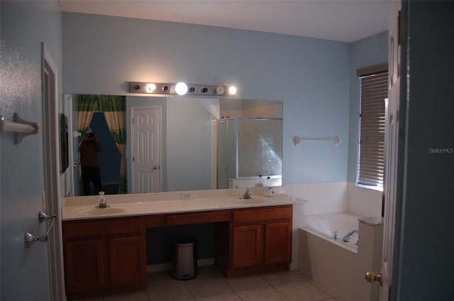 full bathroom with double vanity, a garden tub, tile patterned flooring, a shower stall, and a sink