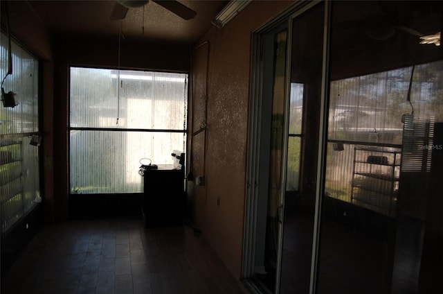 sunroom featuring a ceiling fan