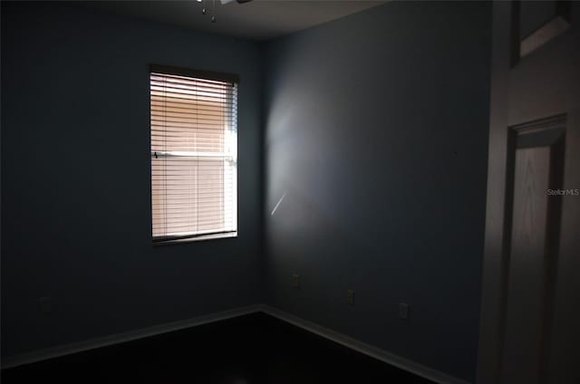 spare room featuring baseboards and a ceiling fan