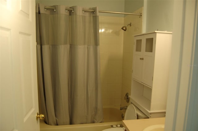 bathroom featuring shower / bath combo, vanity, and toilet