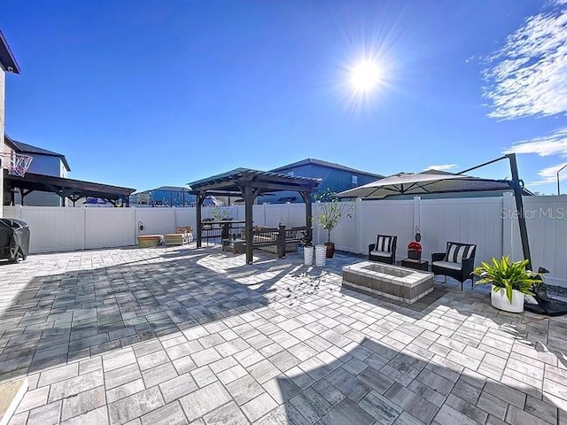 view of patio featuring a fenced backyard, a fire pit, and a pergola