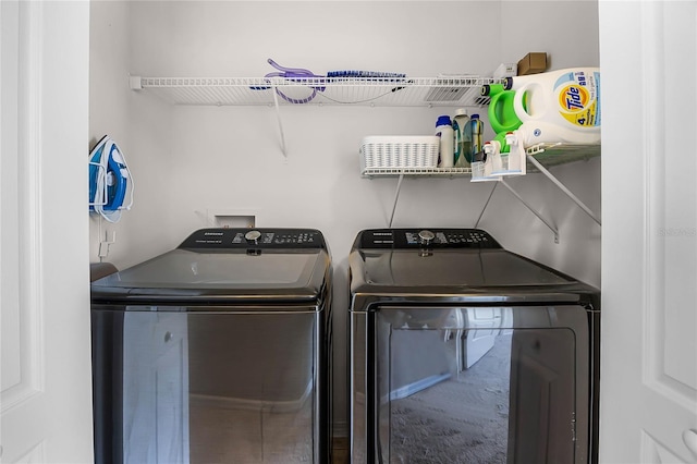 clothes washing area with laundry area and independent washer and dryer