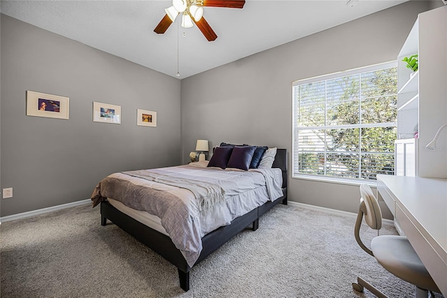 bedroom featuring baseboards, a ceiling fan, and light colored carpet