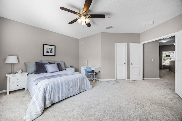 carpeted bedroom with visible vents, ceiling fan, a textured ceiling, and baseboards