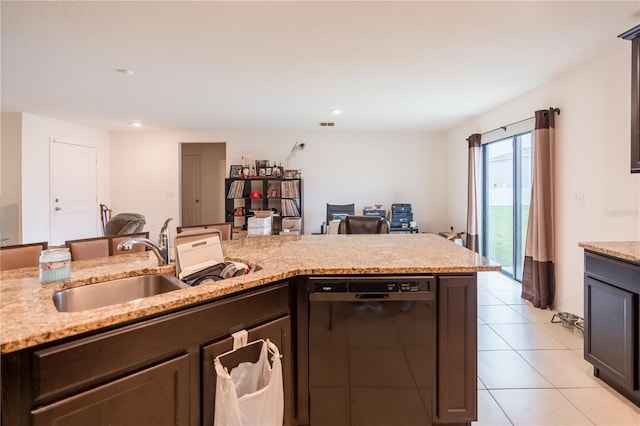 kitchen featuring light tile patterned floors, open floor plan, a sink, light stone countertops, and dishwasher