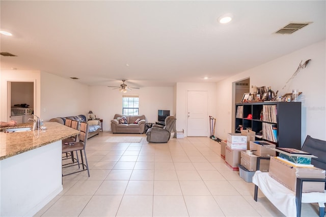 living room featuring light tile patterned floors, ceiling fan, visible vents, and recessed lighting