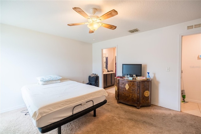 bedroom featuring baseboards, visible vents, and light colored carpet