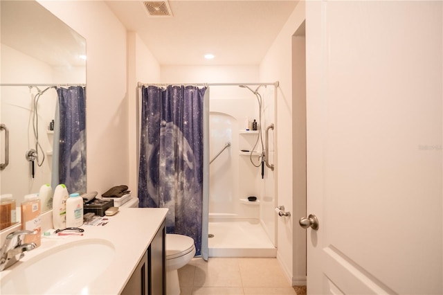 bathroom with visible vents, toilet, vanity, a shower with curtain, and tile patterned floors