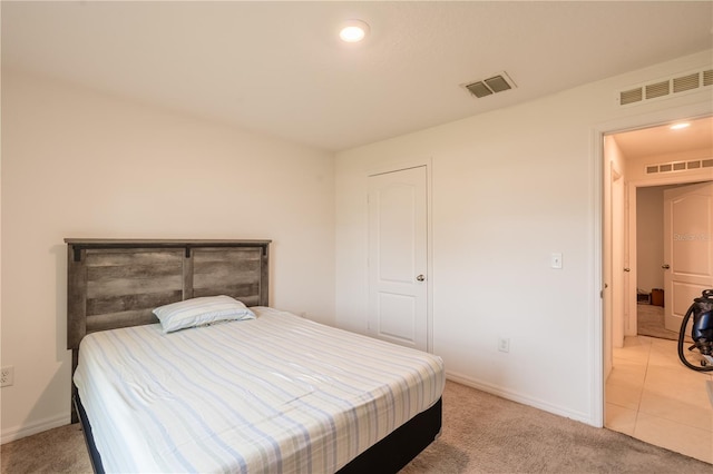 bedroom featuring light carpet, visible vents, and baseboards