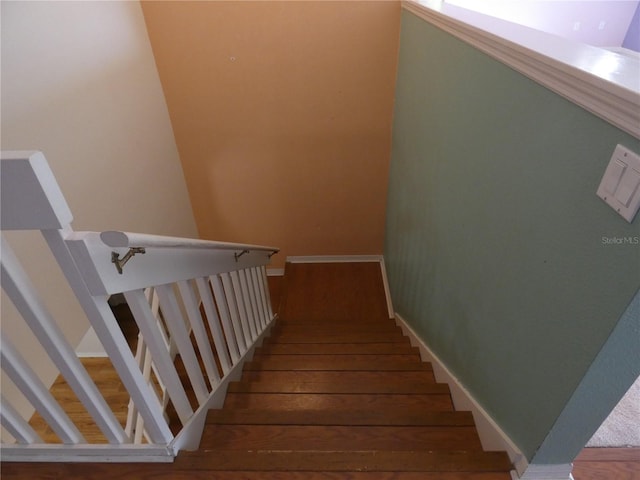 stairs featuring baseboards and hardwood / wood-style floors