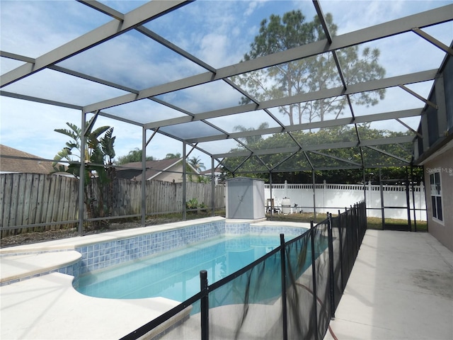 view of swimming pool with a fenced in pool, a patio area, glass enclosure, and a fenced backyard